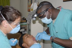 two dentists attending to a patient